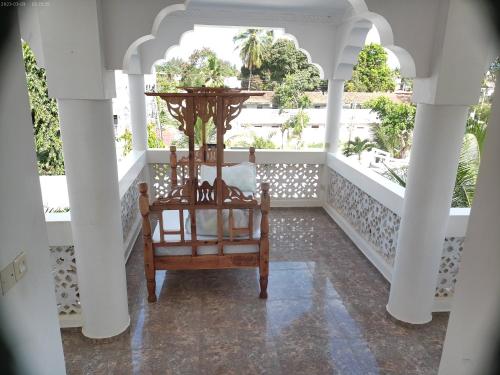 a rocking chair on the porch of a house at Milalana Guest Hotel & Residences in Malindi