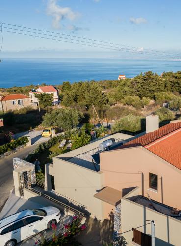 an aerial view of a building with a car parked in a parking lot at Olimpia Villas I Luxury villas with private pools! in Epáno Kefalás