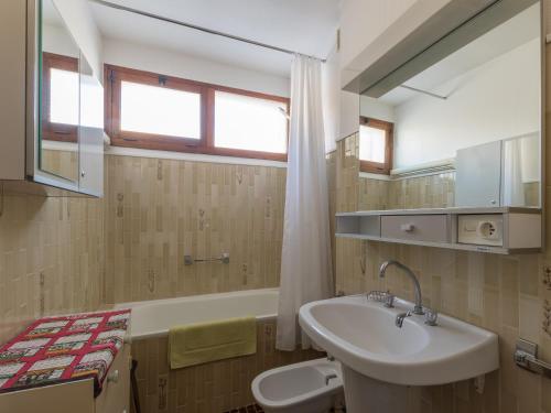a bathroom with a sink and a bath tub at Les Marmottes 2 N 69 - 3P7 in Orcières