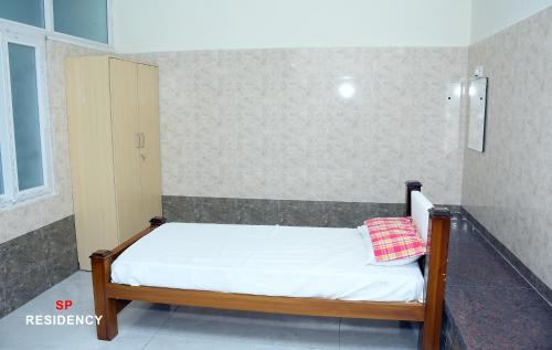 a small bedroom with a bed in a room at S P Residency Premium Service Apartments in Pudukkottai