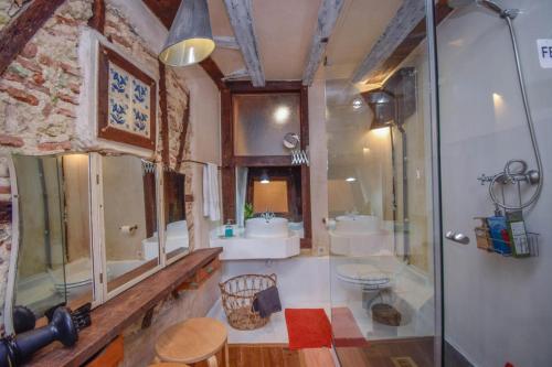a bathroom with a shower and a sink and a toilet at Alfama Charming and Rustic in Lisbon