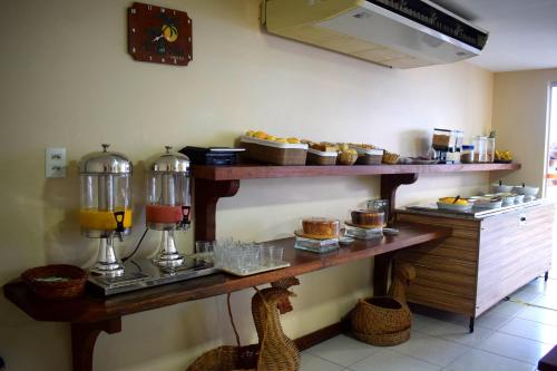 a shelf with some pastries and other food on it at Alto da Praia Hotel in Aracaju