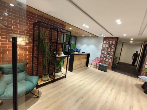 a room with a brick wall and a man standing in the background at Casa Hotel, Jubilee Hills in Hyderabad