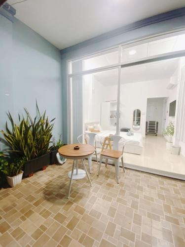 a room with a table and chairs and a living room at SAIGONESE Studio in Ho Chi Minh City