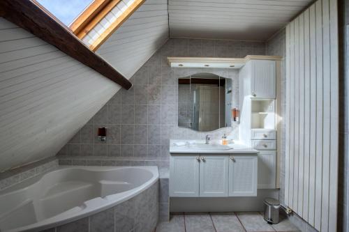 un bagno con vasca e lavandino di Crazy Villa Le Tertre 28 - Heated pool - Basket - 2h Paris - 44p a Courtalain