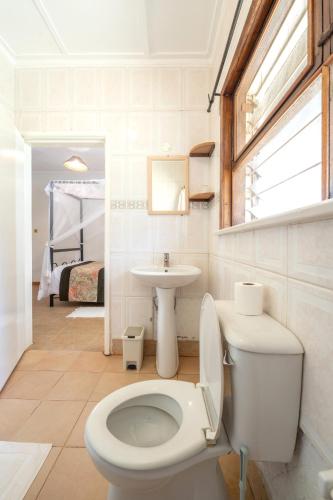 a bathroom with a toilet and a sink at Masindi Hotel in Masindi