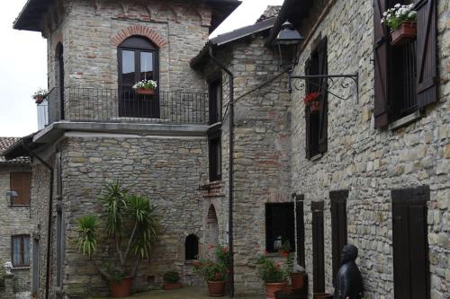 a stone building with a statue in front of it at Il borgo come in un castello in Montabone