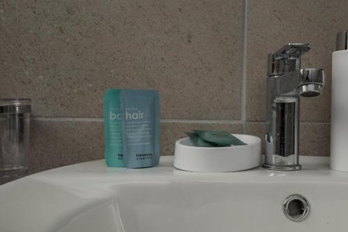 a bathroom sink with a bottle of deodorant on it at Tenuta La Radicale - ZENO 61 intera villa in Subiaco