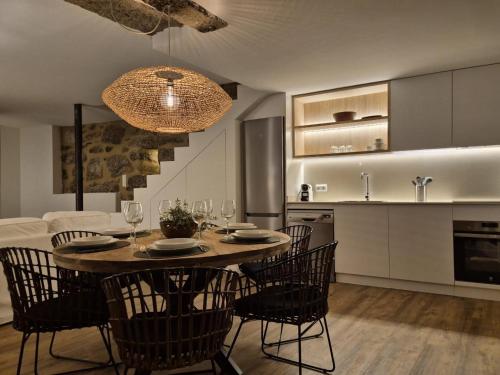 a kitchen and dining room with a table and chairs at YourHouse O Canton II villa in Lobios