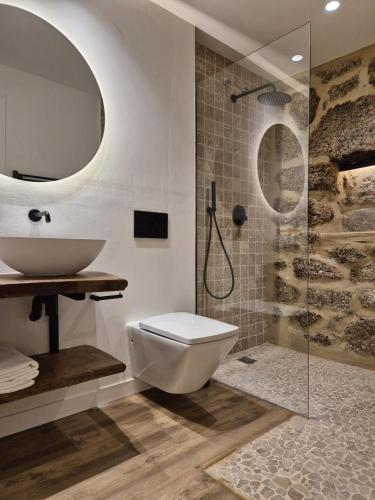 a bathroom with a toilet and a sink and a shower at YourHouse O Canton II villa in Lobios