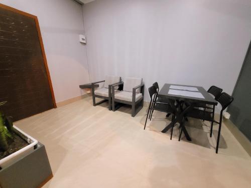 a dining room with a table and chairs in a room at Areca Homestay in Guwahati