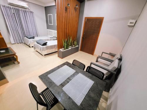 a view of a living room with a table and chairs at Areca Homestay in Guwahati