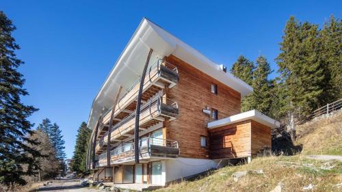 un bâtiment avec des balcons sur le côté dans l'établissement V du Bachat - Sorbiers F N 11 - 2P6, à Chamrousse