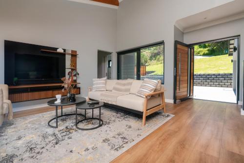 a living room with a couch and a tv at Friznite in Brenton-on-Sea
