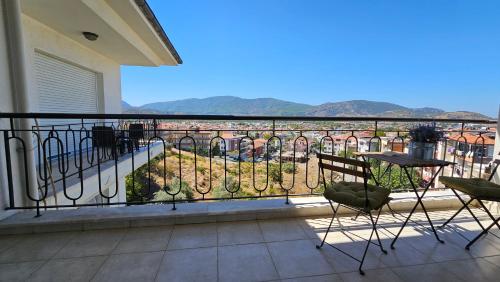 a balcony with chairs and a table and a view at Ephesus Suites in Selcuk