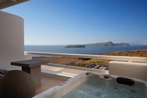 a bath tub with a view of the ocean at Absolute Paradise Santorini in Akrotiri