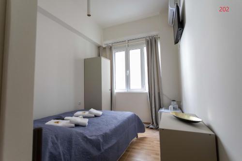 a bedroom with a bed with towels on it at ATHENS COMMERCIAL in Athens