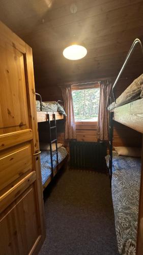 a small room with two bunk beds and a window at Avon Tyrrell Outdoor Activity Centre in Bransgore