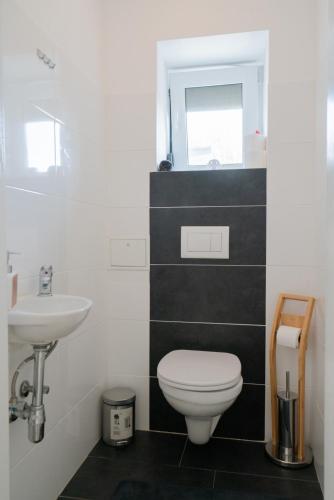 a bathroom with a toilet and a sink at Domus Optima - Cozy Retreat in Vienna in Vienna