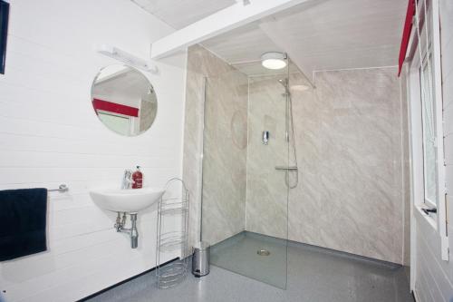 a bathroom with a sink and a shower at Kits Coty Glamping in Maidstone