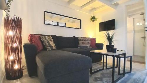 a living room with a couch and a table at Guesthouse with loft at lake Skagern Spa & Yoga in Finnerödja