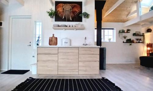 a kitchen with a counter with a picture of an elephant on the wall at Guesthouse with loft at lake Skagern Spa & Yoga in Finnerödja