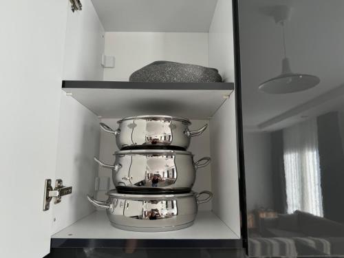 a shelf with pots and pans in a kitchen at Zephyros in Alsancak