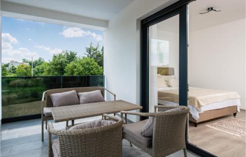 a bedroom with a bed and a table and chairs at Stunning Home In Labin With Wifi in Labin
