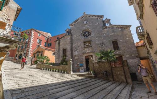 an old stone building on a cobblestone street at Stunning Home In Labin With Wifi in Labin