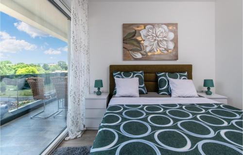 a bedroom with a bed and a balcony at Stunning Home In Labin With Wifi in Labin