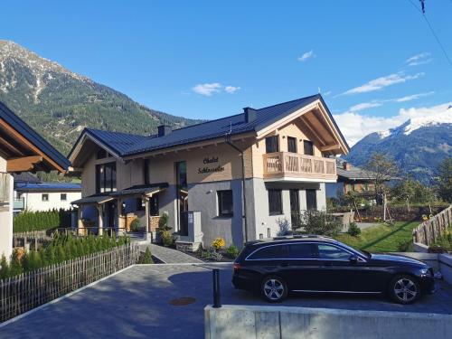 a black car parked in front of a house at Schlossalm Appartement in Bad Hofgastein