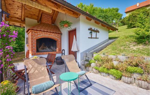 a patio with chairs and a fireplace in front of a house at 2 Bedroom Nice Home In Donja Stubica in Donja Stubica