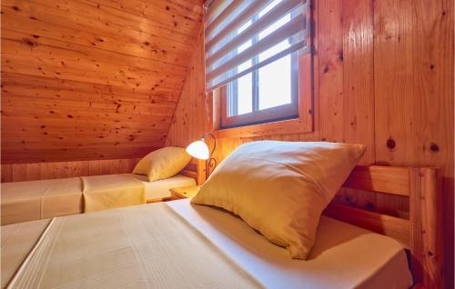a bedroom with two beds in a wooden cabin at 2 Bedroom Nice Home In Donja Stubica in Donja Stubica