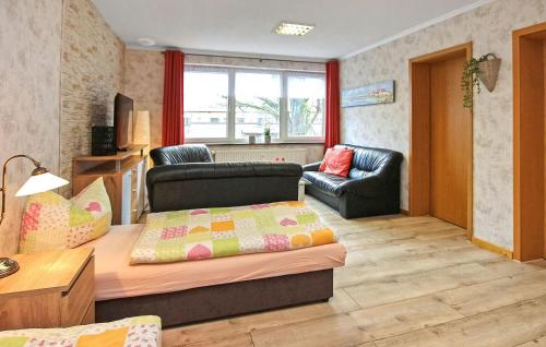 a living room with a couch and a chair at Ferienwohnung Neustrelitz in Neustrelitz