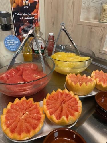 a counter top withspectrued fruit in bowls and other ingredients at Ibis Styles Crolles Grenoble A41 in Crolles