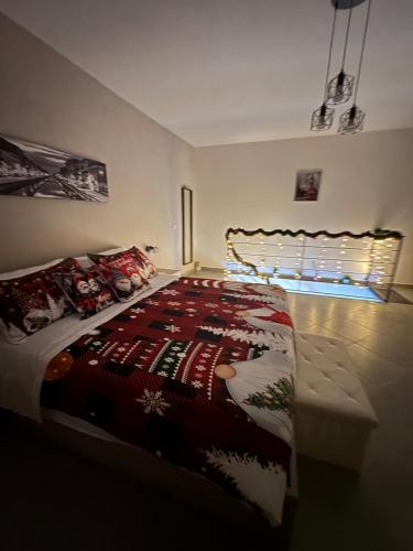 a bedroom with a bed with a christmas quilt on it at La farfalla del vicolo in Larino