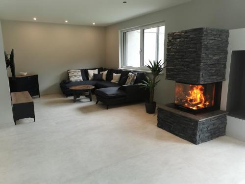 a living room with a couch and a fireplace at Schlossalm Appartement in Bad Hofgastein