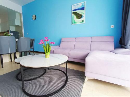 a living room with a purple couch and a table at Bella Vista Silverscape Seaview Homestay in Melaka