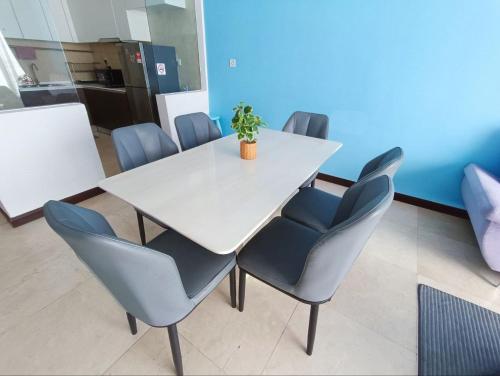 a table with chairs and a potted plant on it at Bella Vista Silverscape Seaview Homestay in Melaka