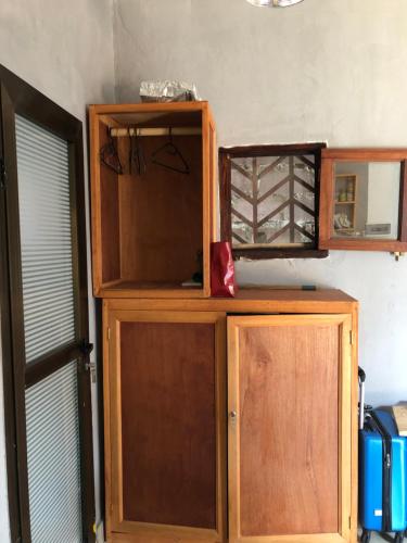 a wooden cabinet in a room with a window at Brazzaville agréable Studio, Square Home Heart in Brazzaville