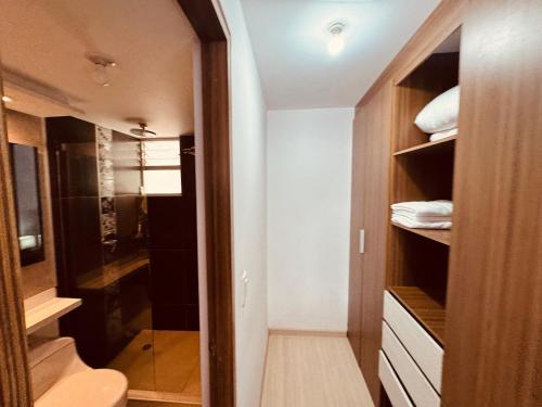 a small bathroom with a toilet and a shower at Aparta-hotel Eskala UPTC in Tunja