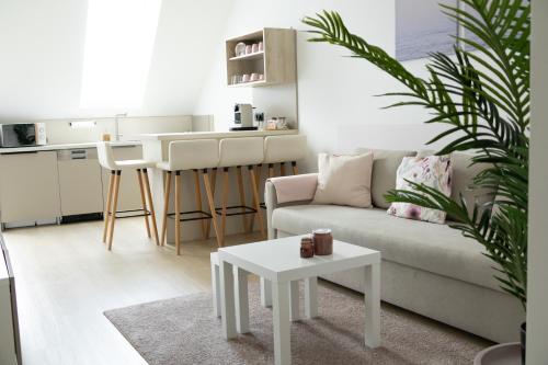a living room with a couch and a table at SI apartments - Smart Inn in Vienna