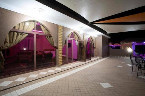 a room with purple walls and tables and chairs at Luxury Villa at the foot of the Grand Atlas in Tillouna