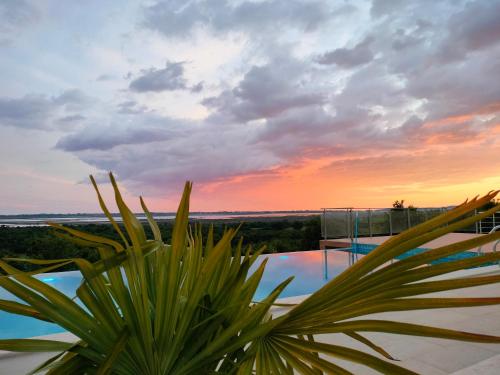 a view of the sunset from a house with a plant at Solana's View - Ferienhäuser in ruhiger Lage, mit einer einzigartigen Aussicht, Infinity Pool, Free Parking und Wlan in Ulcinj