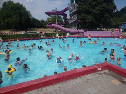 a large group of people in a swimming pool at Your Private Zeeland Getaway - Cosy Home With Large Garden in Heinkensand