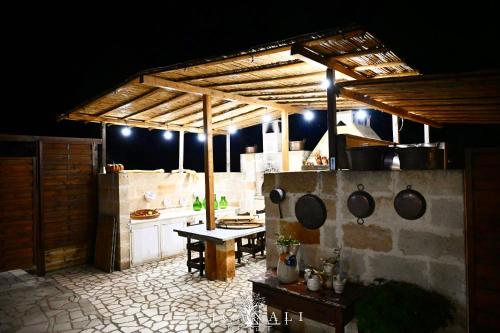 an outdoor kitchen with a table and a stove at Li Canali Reali in Mesagne