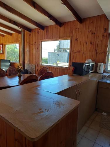 a kitchen with wooden walls and a counter top at Casa cerro Tacna Maitencillo in Maitencillo
