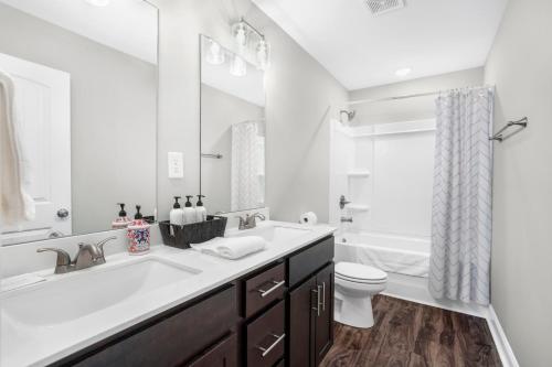 a white bathroom with a sink and a toilet at Touch Of Jazz-workspace 300mbps Wifi in Clarksville