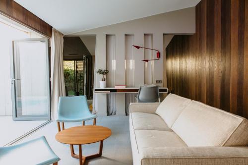 a living room with a couch and a table at Sezz Saint-Tropez in Saint-Tropez