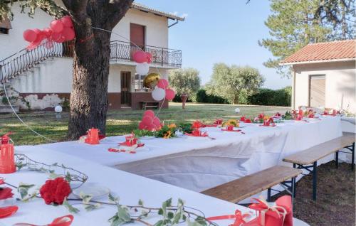 a group of tables with red flowers on them at Awesome Home In Cingoli With Wifi in Cingoli
